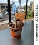 Small photo of Yogyakarta - May 07, 2023: Tempo Gelato is a popular gelato shop located in Yogyakarta and a photo of a gelato with a combination of 3 flavors with a blurred background.