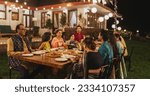 Small photo of Big Indian Family Celebrating Diwali: Family Gathered Together on a Dinner Table in a Backyard Garden Full of Lights. Group of People Sharing Food, Laughs and Stories on a Hindu Holiday