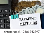 Small photo of PAYMENT METHODS - words on a white sheet against the background of a calculator, banknotes and pennies. Business and finance concept