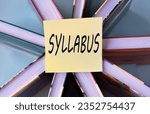 Small photo of SYLLABUS - word on a yellow piece of paper on the background of books. Education concept