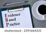 Small photo of EBP (Evidence-based practice) - acronym on a white sheet on a gray background with a pen and a cup of coffee. Info concept