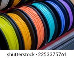 Small photo of Many multi-colored spools of thread of filament for printing 3d printer. Material coils for printing 3D printer. Spools of 3D printing motley different colors filament. ABS wire plastic for 3d printer