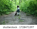 Little girl walking with her toy. Little girl with her toy alone in the forest. Child alone in the forest. Unattended child. Offended girl.Тhe little girl was lost alone in the forest. 