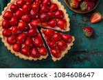 slice of delicious strawberry tart on green background, top view