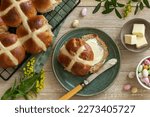Traditional Easter hot cross buns with butter.  Top vew, wooden background, copy space