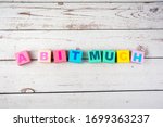 Small photo of "a bit much "-the words on wooden cubes. A background image of english words on colorful building blocks.
