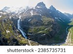Small photo of Amazing scenic route which is called Norwegian Troll road or The Trolls Ladder. Road going through the mountains. Very steap road going up the hill. Amazing road trip destination.