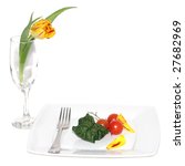 Small photo of Still life of vegetables on a plete and flower in a glass