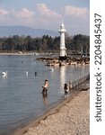 Small photo of Geneva, Switzerland - 25 March 2022: People enjoying the scenic view of the Geneva Lake at the Bay of Geneva, the French section of Switzerland.