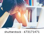 Small photo of Headache Business Woman Working on Laptop in the Office, Soft focus. Thoughtful officer put her hands on head for relax. Jaded, Toilsome, Exhausted Worker in workplace. Fatigue and fail concept