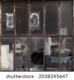 Small photo of Artistic background often amateurish repaired broken industrial window made of iron with different types of glass and glue
