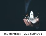 hand shows a rocket and an icon. Concept of Startup Business, Entrepreneurship Idea, and Online Digital Business. network connection on the interface Online Marketing, Technology and Success