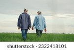 Small photo of men in rubber boots walk through field wheat, business concept agriculture summer, male businessmen made deal, agree job, business agro, agricultural business wheat, caring plants harvest field