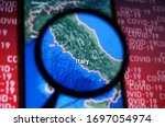 Italy country on google maps under magnifying glass with Red Covid-19 text Background. Selective Focus.                             