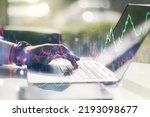 Multi exposure of abstract financial graph with hand typing on laptop on background, financial and trading concept