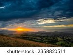 Small photo of Dawn over the horizon in a mountain valley. Valley at dawn. Beautiful sunrise over valley. Mountain valley at dawn