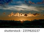 Small photo of Dawn over the horizon under the clouds. Beautiful sunrise over horizon. Horizon at dawn. Cloudy sky at dawn