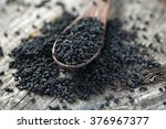 Black Cumin On Wooden Surface