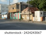 Small photo of Bridgetown, Barbados 02 02 2024: Dilapidated house in typical bright colours and colonial style on the Caribbean island of Barbados in Bridgetown situated near main road.