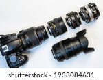 Small photo of camera and photo lenses on white background. Concept of interchangeable lenses and optics. Flat lay, top view.