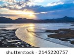 Small photo of Sunset and aerial view of curved sea waterway and mud flat at low tide against sunshine at Suncheon Bay near Suncheon-si, South Korea