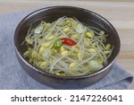 Close-up of Korean Food Bean Sprout Soup with red and green pepper on ceramic bowl, South Korea
