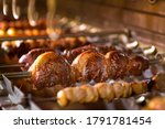 Small photo of Picanha barbecue roasted over hot coals. This form of barbecue is widely consumed throughout Brazil.