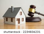 Small photo of House model, hammer judge gavel on wooden table with white wall background. Foreclosure, bankruptcy concept. Person is unable to repay outstanding debts or obligations, stops mortgage payment.