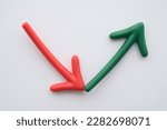 Small photo of Arrow red fall and green rise up rebound volatility on white background. Business, financial and investment concept. Risk management, fluctuation in stock market, cryptocurrency and other investment.
