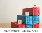 Small photo of Shipping containers as graph chart growth and FTA letters with white wall background. Concept of free trade agreement (FTA), global international trade, world economic, investment, cargo shipping.