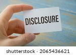 Small photo of Text Disclosure on card. Concept meaning The action of making New or Secret Confidential information.