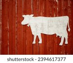 Small photo of Red rustic wooden barn facade with cow stencil for text, farming concept
