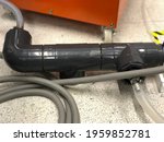 Selective focus Flexible water supply hoses connect with PVC pipe, used for industrial water treatment supply to manufacturing machine, out of focus, noise and grain effects.