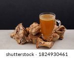 Small photo of Transparent Cup of bone broth is placed on boiled beef bones, which contain the necessary amino acids for the body. Selective focus