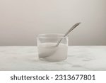 Small photo of Xanthan gum dissolved in water. Mixture is widely used in food industry for thickening gluten-free products, pastries and beverages. Food additive E415. Stabiliser and Thickener.