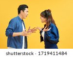 Small photo of Profile side view portrait of two attractive angry aggressive nervous people having fight anger blame isolated over vivid shine bright orange background. Negative emotions concept.