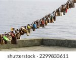 Small photo of Sopot, Poland - 01 19 2020: many locks on a chain, Sopot embankment, Sopot pier, locks with autographs left by tourists