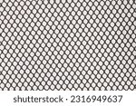 Regular cells of black mesh fabric isolated on grey background