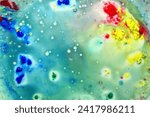 Small photo of A drawing created with several paints, different shades, diluted in a liquid with the addition of bubbles.