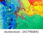 Small photo of A drawing created with several paints, red, yellow, green and blue, diluted in a liquid with the addition of bubbles.