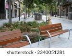 Recreation area, benches, tables on a green street in a modern c