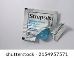 Small photo of SiDOARJO, INDONESIA - May 01, 2022 : Strepsils, lozenges used to provide relief when a sore throat. Isolated on a white background
