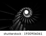 Spiral staircase with steps, upward view of a skylight, in monochrome