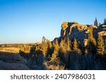 Small photo of Boulder fields of Vedauwoo in Wyoming. Sherman Granite boulders in Medicine Bow -Routt National Park. Vedauwoo boulders in afternoon sun with dark blue sky and scrub trees.