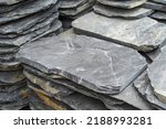 Stack flat slate stones cladding of wall used for flooring, walkways or wall decoration.Background texture
