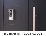 detail of an entrance door to a house with a doorbell with camera