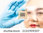 Small photo of Selective focus new processor in hands. Blur background of engineer working in a lab wearing protective goggles and gloves. Women holding chipset in laboratory Computer, technology, hardware, cpu