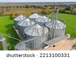 Small photo of Agricultural silos on the farm in autumn, close-up drone view. Industrial granary, elevator dryer, building exterior, storage and drying of grain, wheat, corn, soy, sunflower. Europe in Hungary