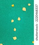 Small photo of Green background with yellow autumn leaves. Green gravel. Autumn weather, brighter days. Suitable for postcards, promotions, websites, printing, social networks.