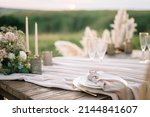 Boho wedding table set. vintage dining table with decorations, flowers and pampas grass  Boho style. Table set for an event, party, date or wedding.